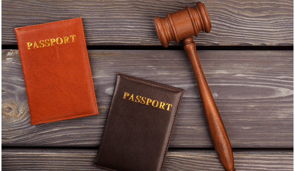 Wooden gavel and passports. Old wooden background.