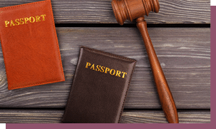 Wooden gavel and passports. Old wooden background.